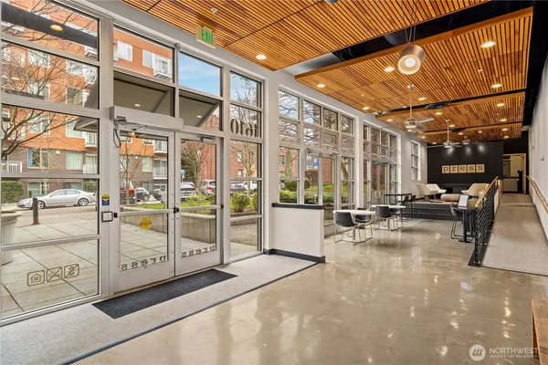 a view of a lobby with a floor to ceiling windows with a flat tv screen