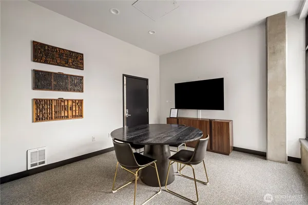 a dining room with furniture and wooden floor