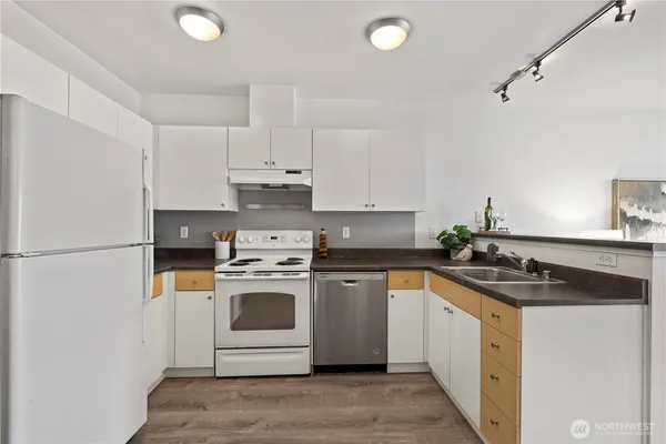 a kitchen with a stove sink and cabinets