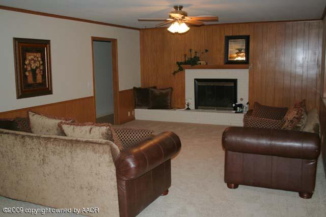 6904 Elmhurst Road Amarillo, TX 79106 - Photo 2 of 15 a living room with furniture and a fireplace