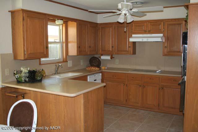 6904 Elmhurst Road Amarillo, TX 79106 - Photo 4 of 15 a kitchen with a sink cabinets and window
