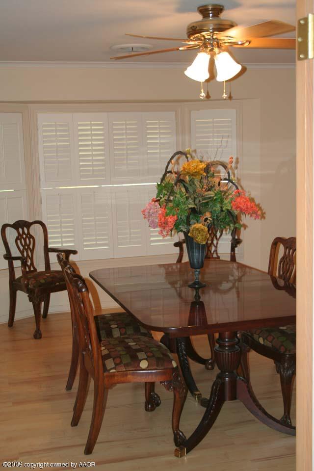 6904 Elmhurst Road Amarillo, TX 79106 - Photo 6 of 15 a view of a dining room with furniture and chandelier