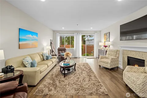 a living room with furniture fireplace and flat screen tv