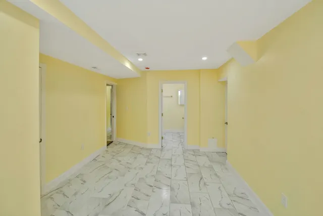 a view of a hallway with wooden shelves