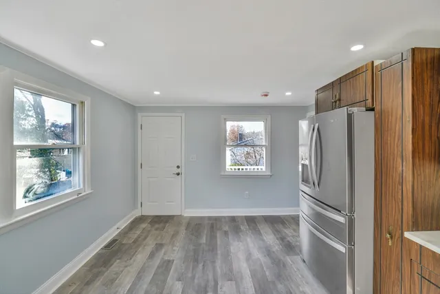 a view of kitchen with stainless steel appliances a refrigerator and a window