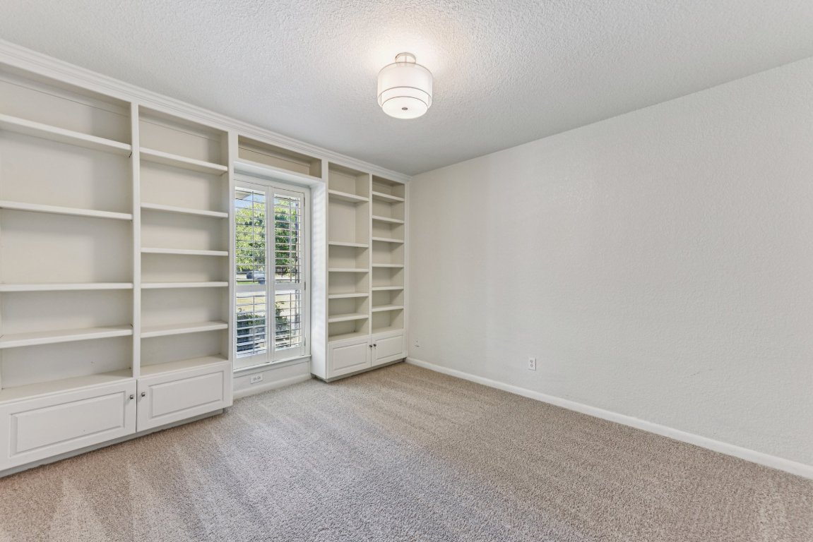 503 Hackberry Street Lockhart, TX 78644 - Photo 24 of 36 Spare room featuring light colored carpet and a textured ceiling