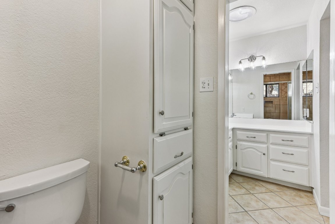 503 Hackberry Street Lockhart, TX 78644 - Photo 29 of 36 Bathroom with a textured wall, vanity, and light tile patterned flooring