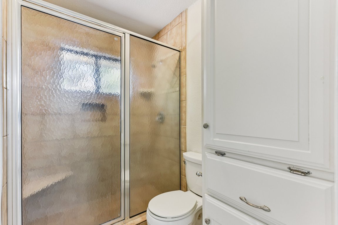 503 Hackberry Street Lockhart, TX 78644 - Photo 30 of 36 Bathroom featuring a shower stall and toilet