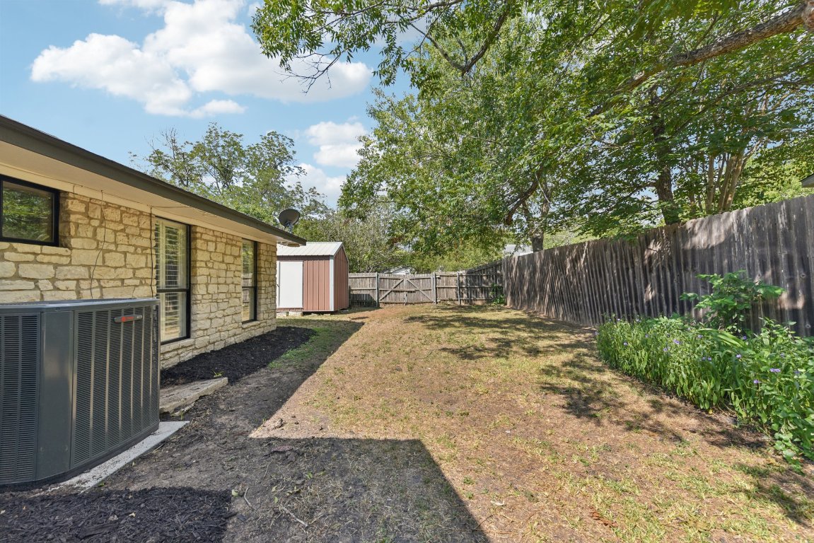 503 Hackberry Street Lockhart, TX 78644 - Photo 33 of 36 Fenced backyard with a shed