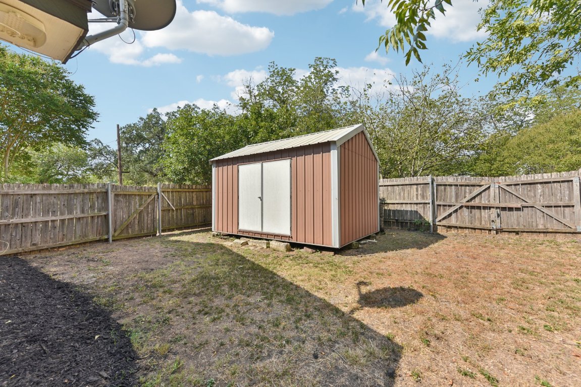 503 Hackberry Street Lockhart, TX 78644 - Photo 35 of 36 View of shed with a gate and a fenced backyard
