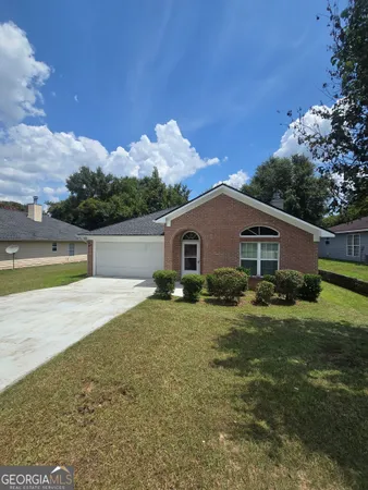 a front view of a house with garden