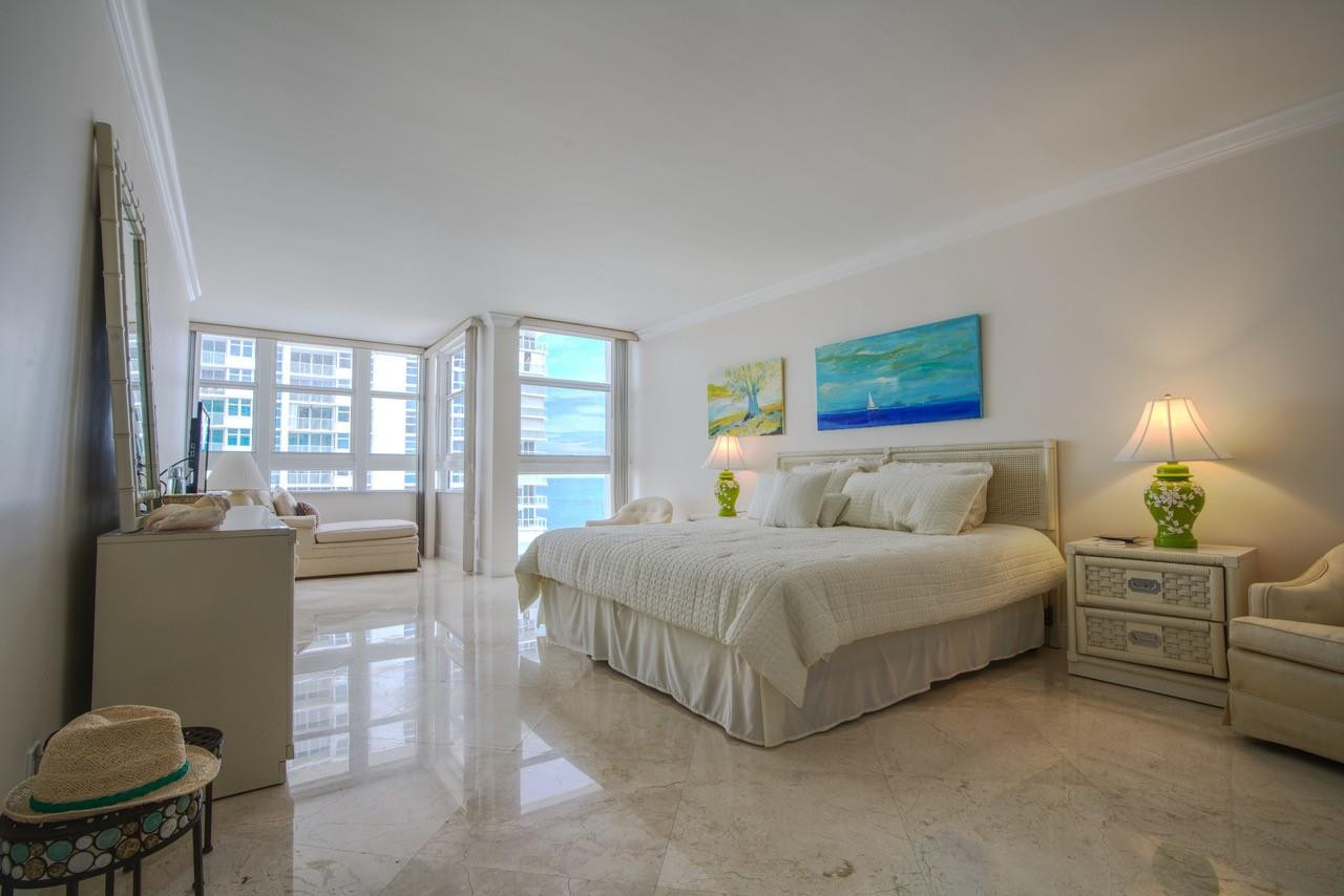 Undisclosed Address Pompano Beach, FL 33062 - Photo 13 of 55 a spacious bedroom with a bed and large windows