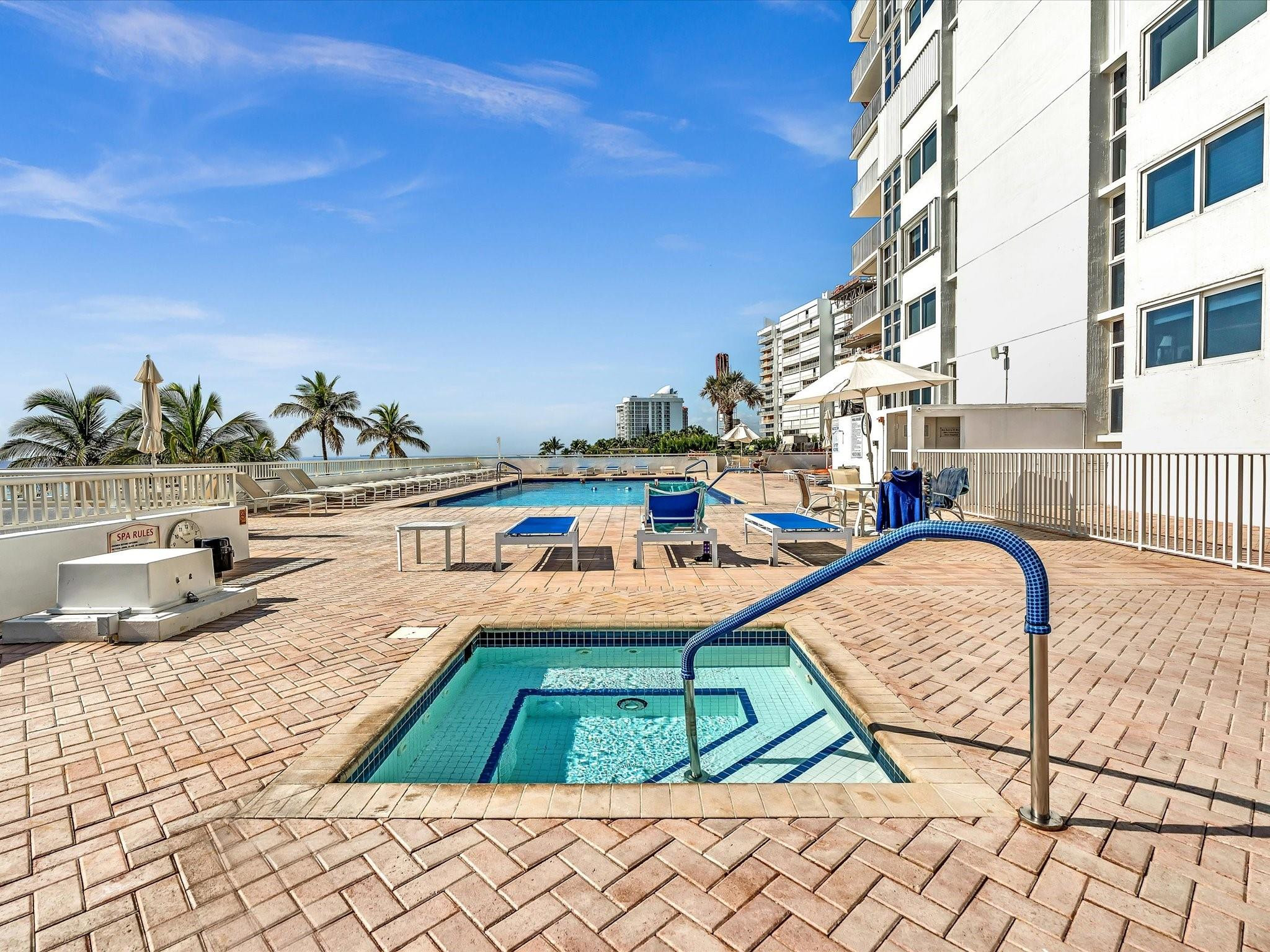 Undisclosed Address Pompano Beach, FL 33062 - Photo 42 of 55 a view of a swimming pool with a lounge chairs