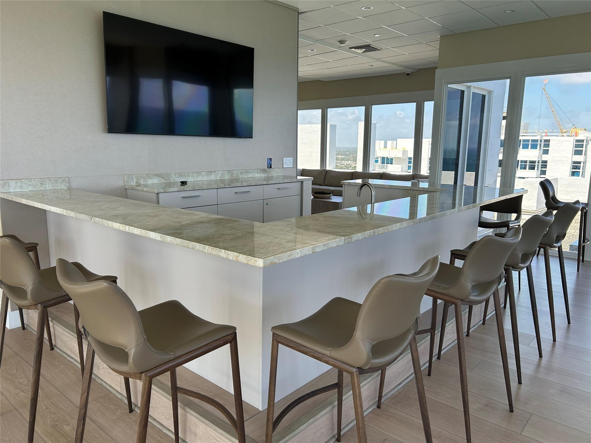 Undisclosed Address Pompano Beach, FL 33062 - Photo 52 of 55 a kitchen with a dining table chairs and granite counter tops