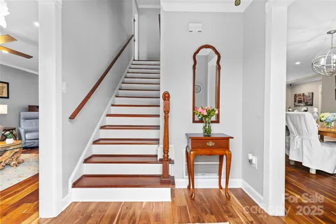 a view of entryway and hall with wooden floor