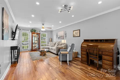 a living room with furniture and a wooden floor