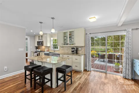 a dining room with furniture a chandelier and wooden floor