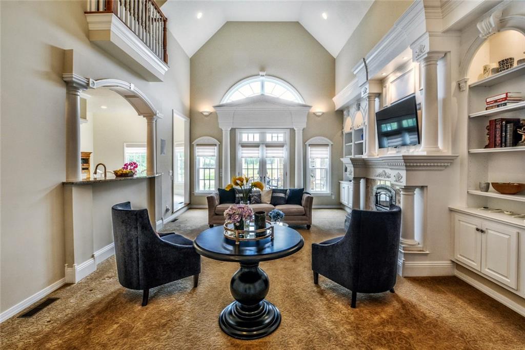 208 Logan Road Gibsonia, PA 15044 - Photo 2 of 25 Commanding great room with a two-story ceiling opening onto an expansive rear stone terrace.