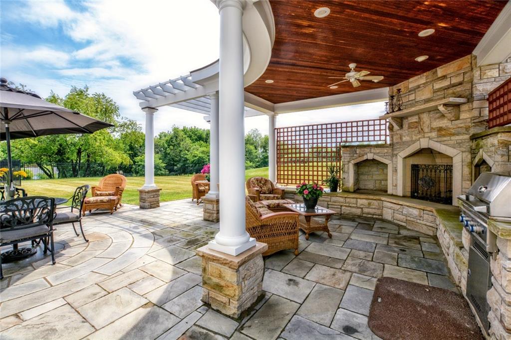 208 Logan Road Gibsonia, PA 15044 - Photo 13 of 25 Breathtaking outdoor entertaining area with pergola, integrated gas grill and wood-burning fireplace.