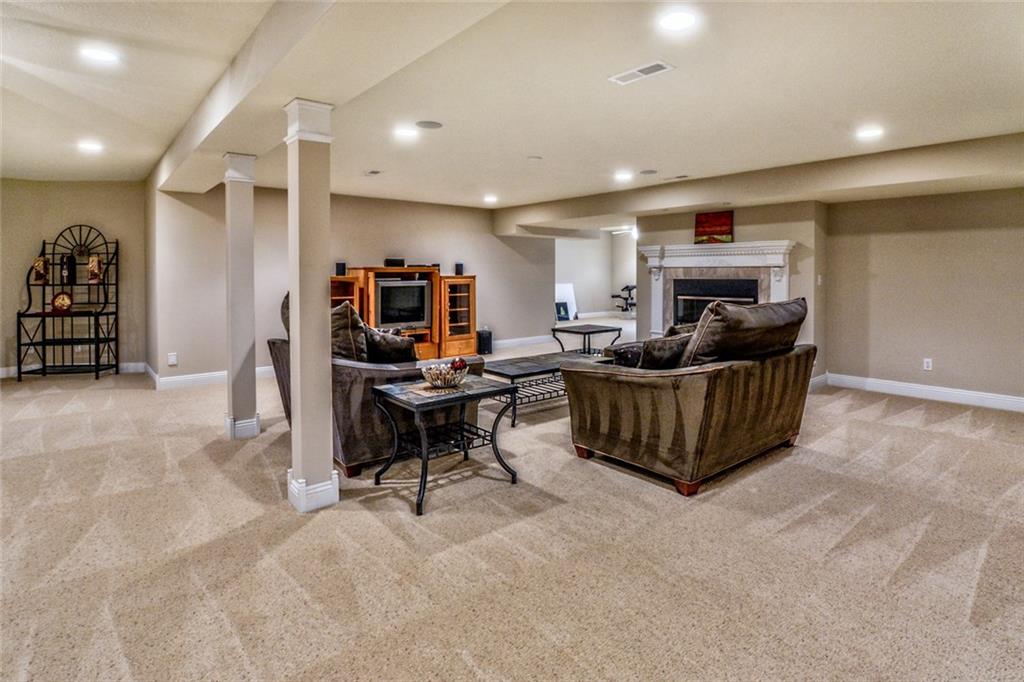 208 Logan Road Gibsonia, PA 15044 - Photo 16 of 25 Expansive lower level featuring a game room with fireplace, kitchen/bar area, exercise room, bedroom and full bath.