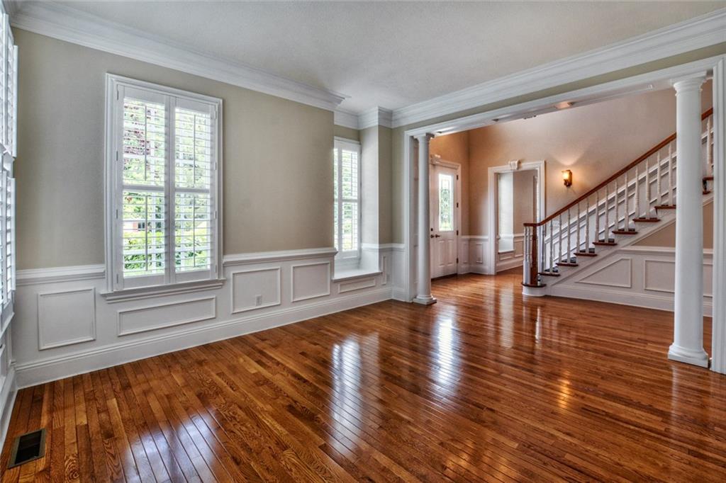 208 Logan Road Gibsonia, PA 15044 - Photo 20 of 25 Formal living room with wainscoting, hardwood flooring and plantation shutters.