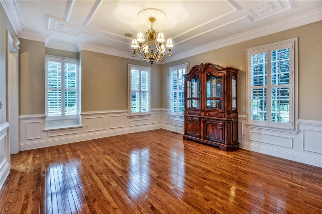 208 Logan Road Gibsonia, PA 15044 - Photo 21 of 25 Formal dining room with detailed ceiling, wainscoting, hardwood flooring and plantation shutters.