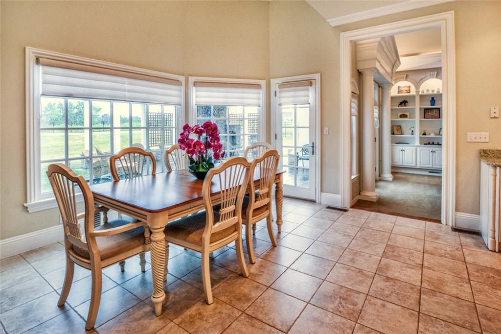 208 Logan Road Gibsonia, PA 15044 - Photo 8 of 25 Sun-filled breakfast area with vaulted ceilings, skylights and lovely views of the private rear yard and pergola.