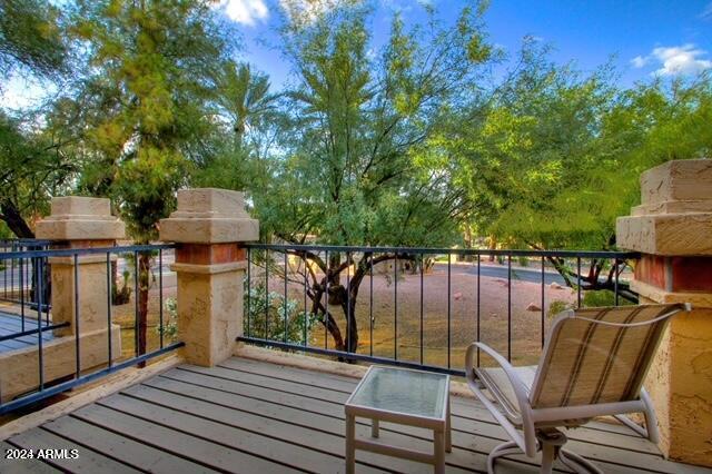 9705 East Mountain View Road, Unit 1021 Scottsdale, AZ 85258 - Photo 2 of 14 a view of a balcony with wooden floor and outdoor seating