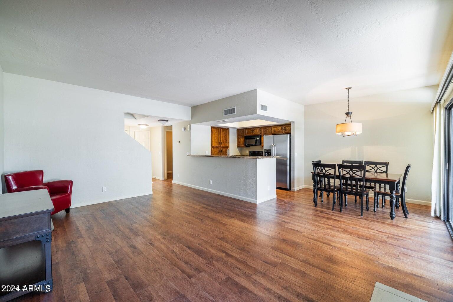 9705 East Mountain View Road, Unit 1021 Scottsdale, AZ 85258 - Photo 4 of 14 a view of a dining room with furniture and wooden floor