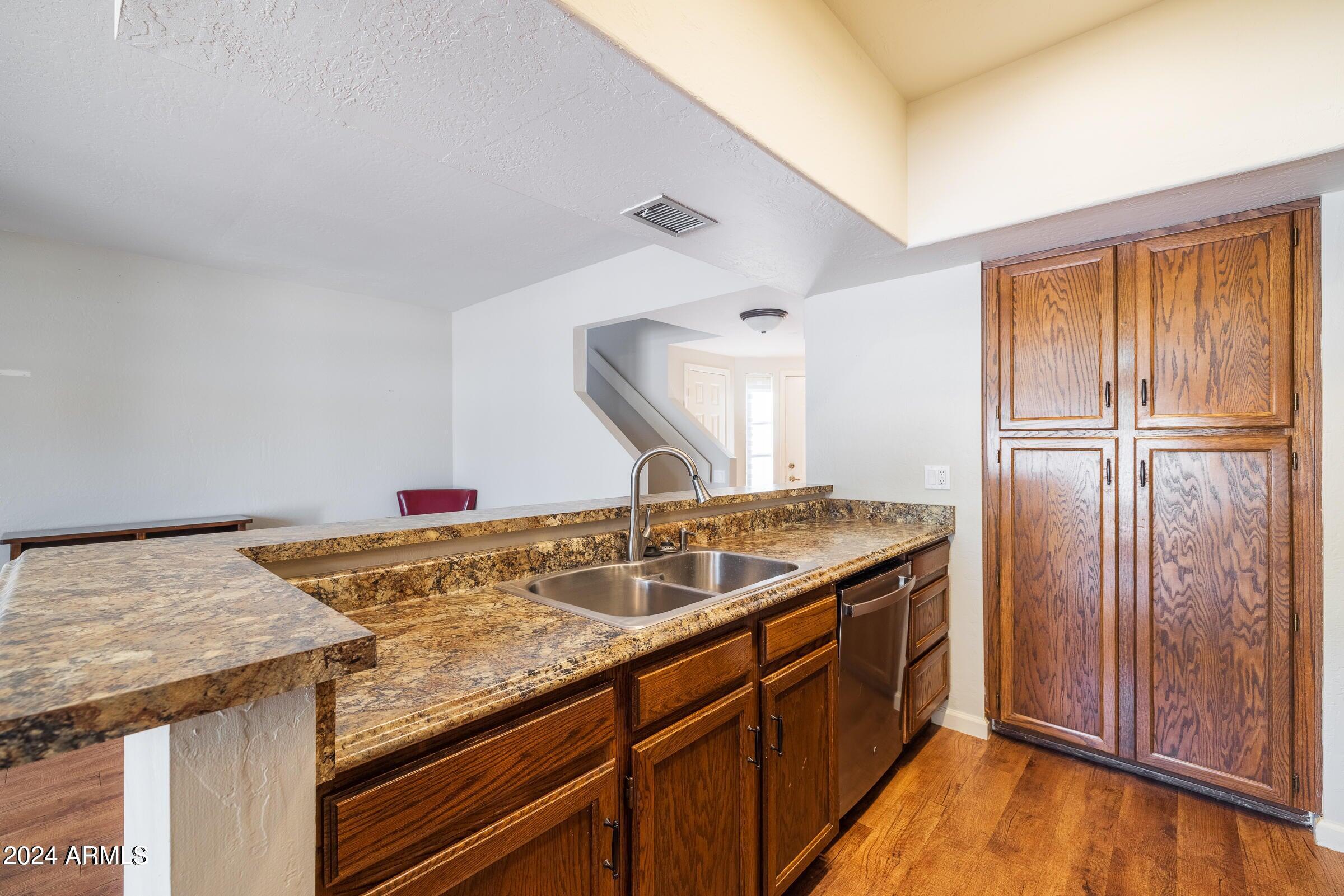 9705 East Mountain View Road, Unit 1021 Scottsdale, AZ 85258 - Photo 6 of 14 a kitchen with a sink and cabinets