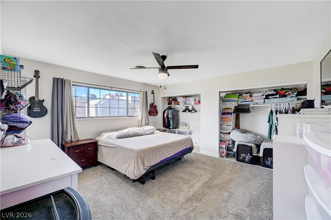 1331 Pinto Road Boulder City, NV 89005 - Photo 25 of 46 A naturally illuminated bedroom offers comfort with soft carpeting and functional open closets.