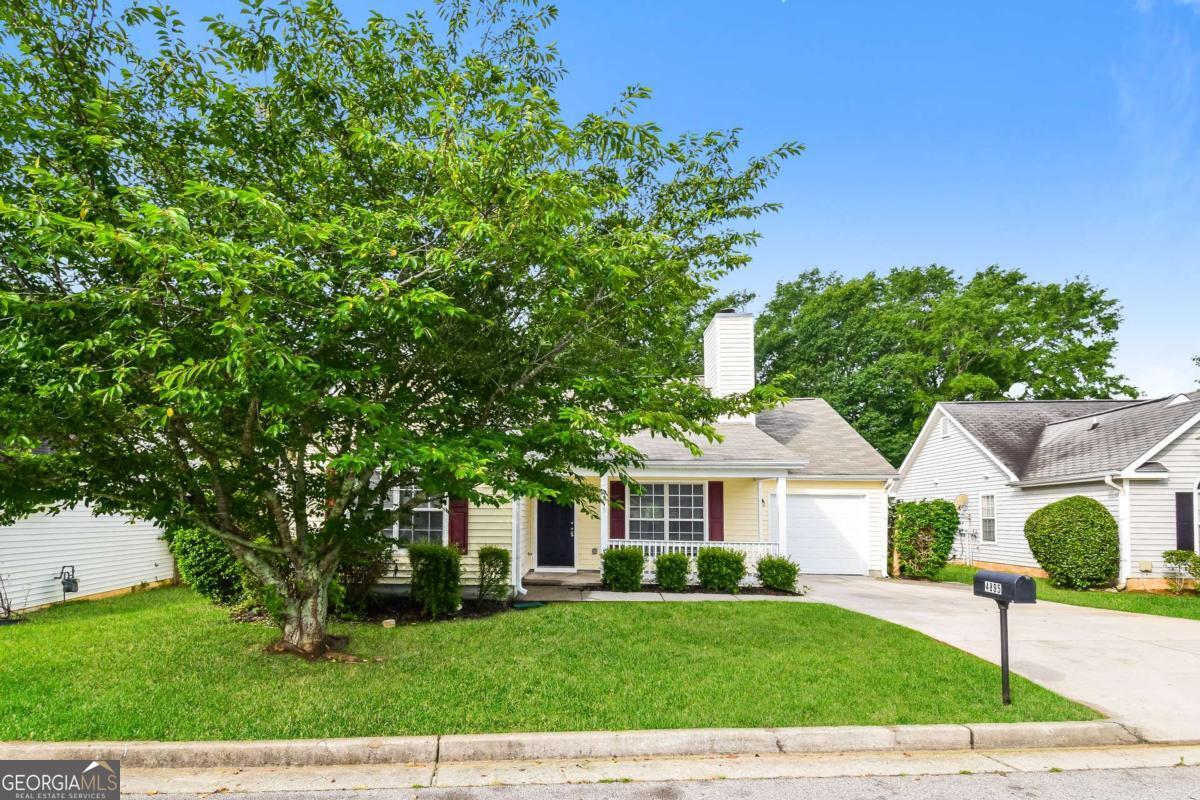 a front view of a house with garden