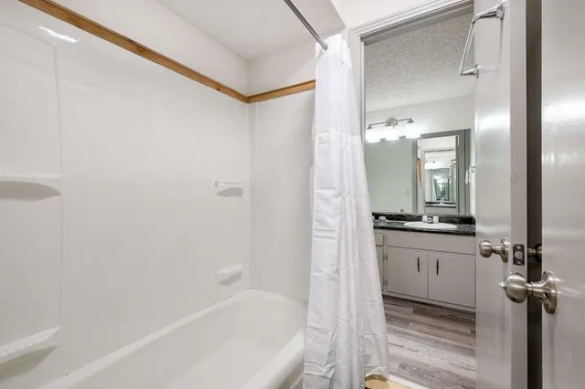 a bathroom with a bathtub and a sink