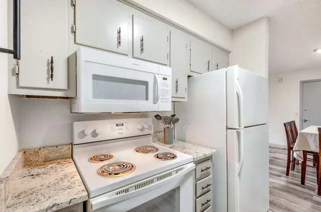 a white refrigerator freezer sitting inside of a kitchen