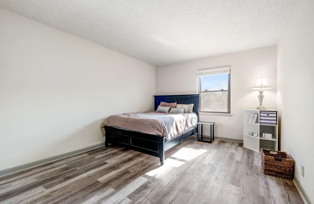 a bed room with a bed and a chair