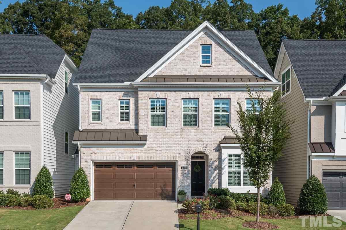 4025 Periwinkle Blue Lane Raleigh, NC 27612 - Photo 1 of 23 a front view of a house with a yard and garage