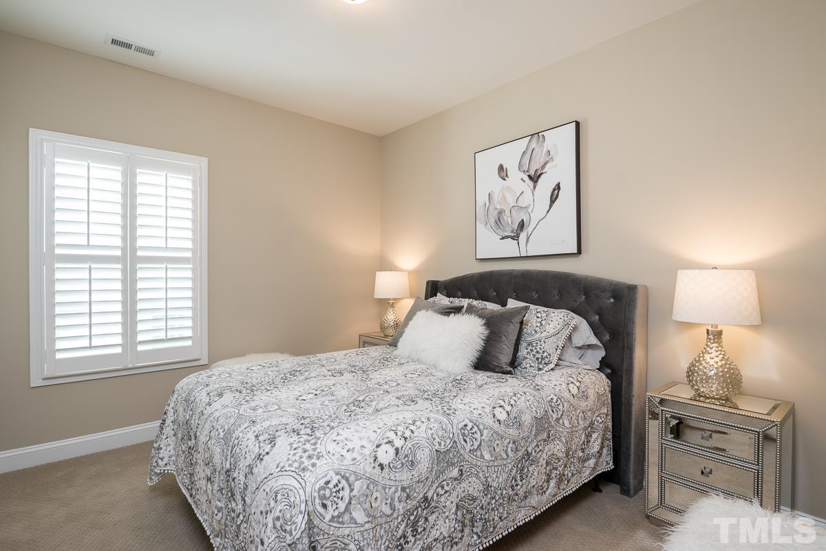 4025 Periwinkle Blue Lane Raleigh, NC 27612 - Photo 15 of 23 a bedroom with a bed and a window