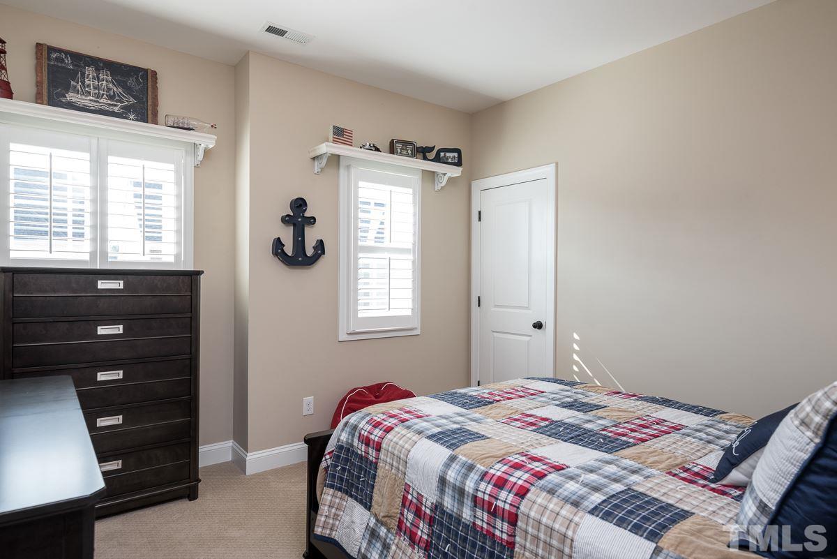 4025 Periwinkle Blue Lane Raleigh, NC 27612 - Photo 16 of 23 a bedroom with a bed and a dresser