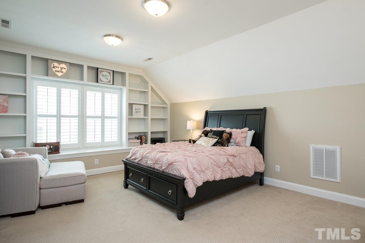 4025 Periwinkle Blue Lane Raleigh, NC 27612 - Photo 18 of 23 a bedroom with a bed couch and a large window