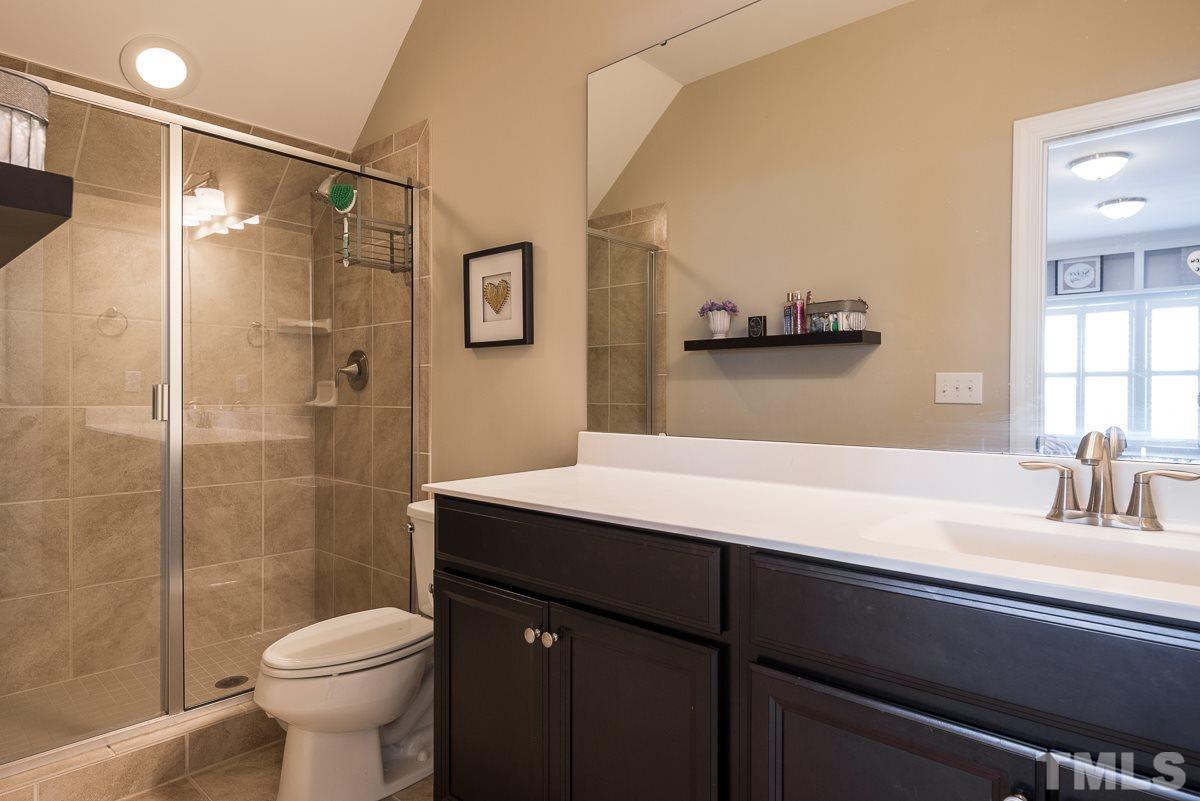 4025 Periwinkle Blue Lane Raleigh, NC 27612 - Photo 19 of 23 a bathroom with a sink a toilet and shower