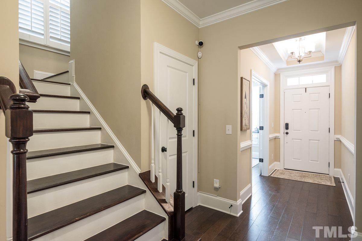 4025 Periwinkle Blue Lane Raleigh, NC 27612 - Photo 2 of 23 a view of a hallway with wooden floor and staircase