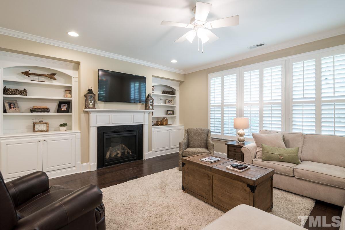 4025 Periwinkle Blue Lane Raleigh, NC 27612 - Photo 9 of 23 a living room with furniture a flat screen tv and a fireplace