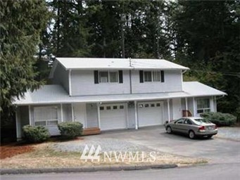 20607 West Richmond Road Bothell, WA 98021 - Photo 1 of 16 a front view of a house with a garden and plants