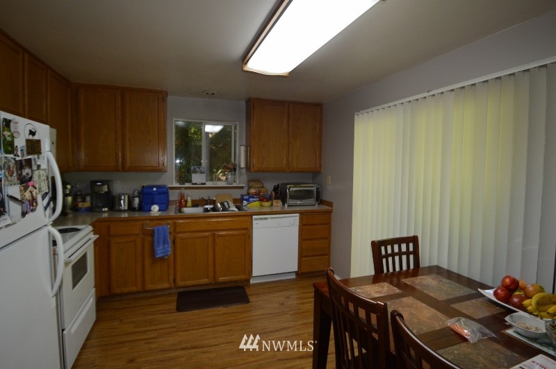 20607 West Richmond Road Bothell, WA 98021 - Photo 2 of 16 a kitchen with a table and chairs in it