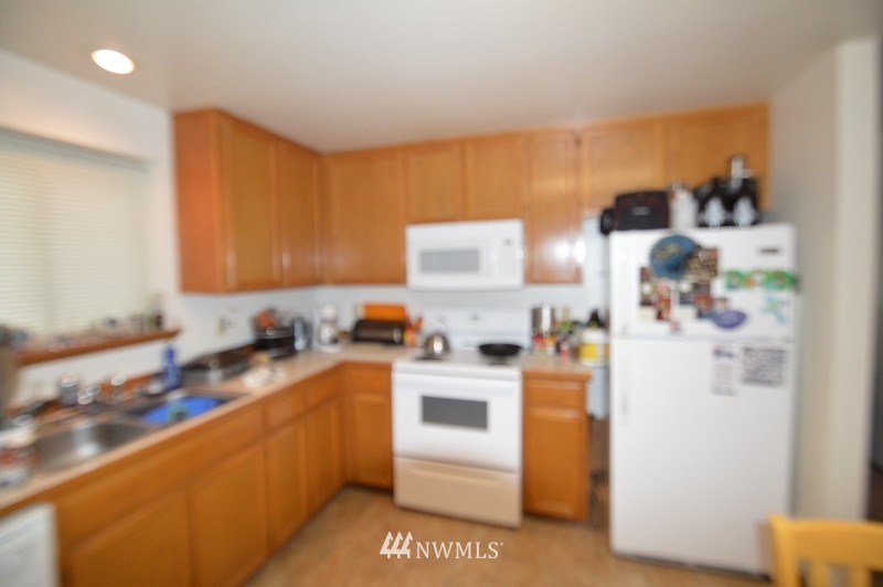 20607 West Richmond Road Bothell, WA 98021 - Photo 14 of 16 a kitchen with a sink a stove and a refrigerator