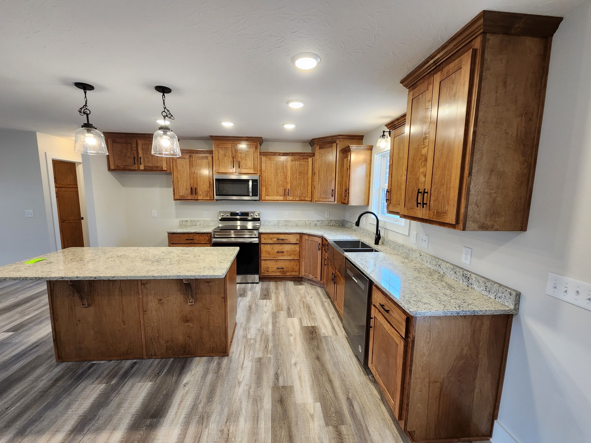 1672 Rock Bridge Road Bethpage, TN 37022 - Photo 15 of 26 a kitchen with kitchen island a counter top space a sink a stove and a refrigerator