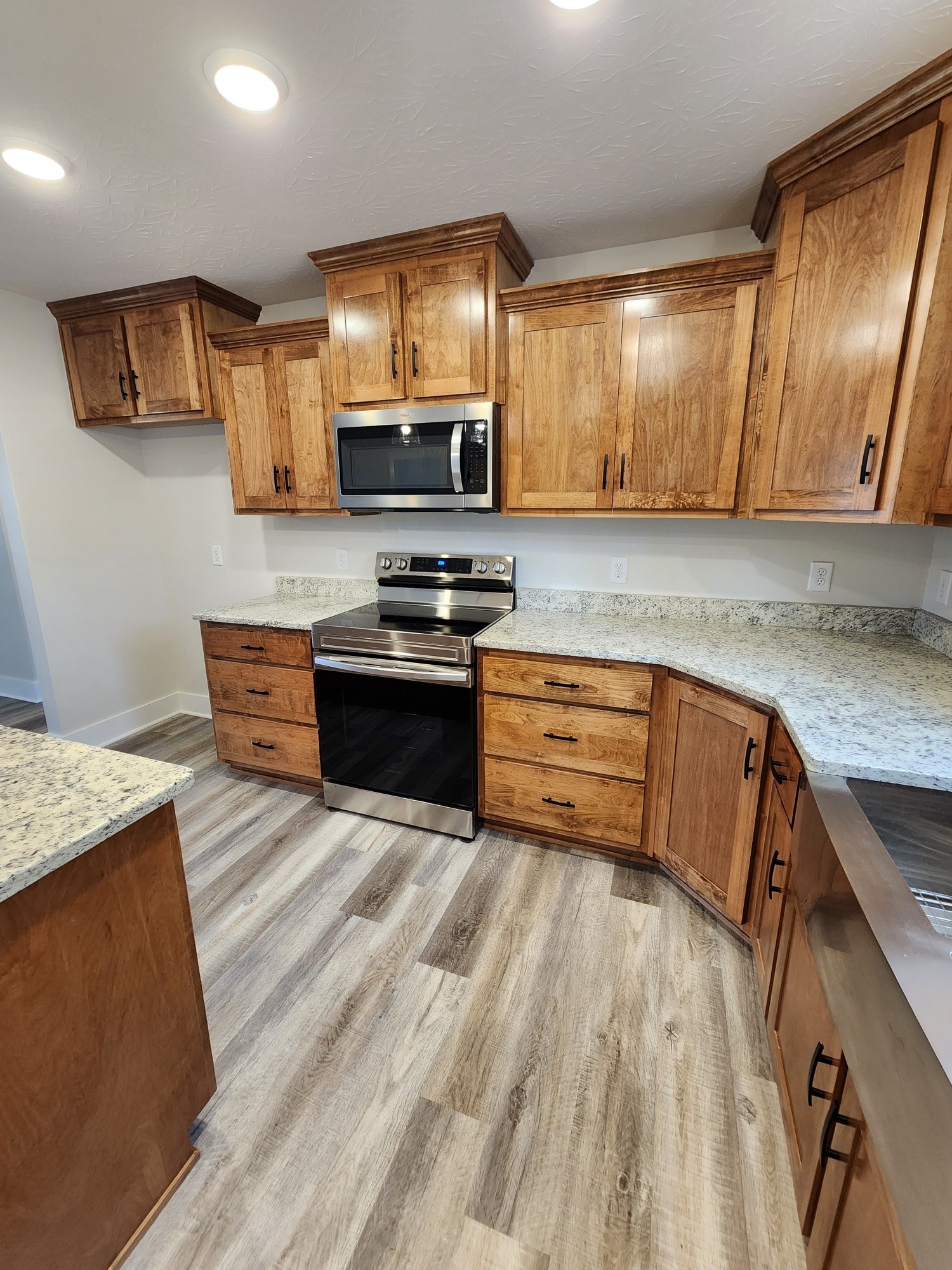 1672 Rock Bridge Road Bethpage, TN 37022 - Photo 16 of 26 a kitchen with stainless steel appliances granite countertop wooden cabinets a stove top oven a sink and dishwasher