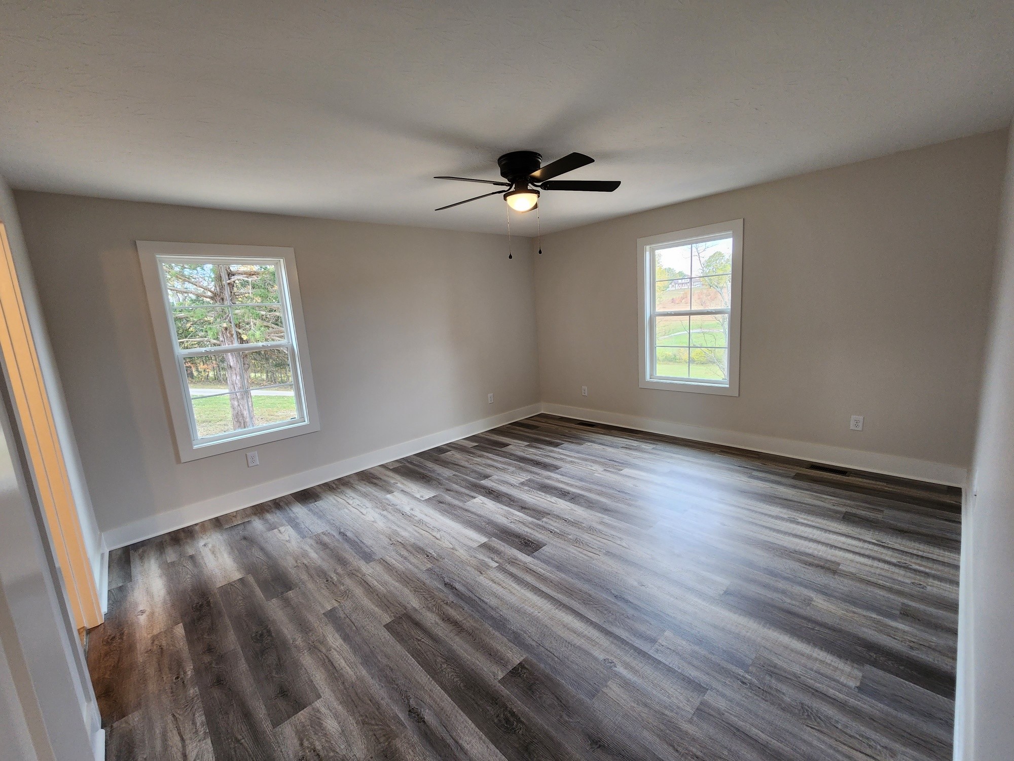 1672 Rock Bridge Road Bethpage, TN 37022 - Photo 18 of 26 a view of an empty room with a window and wooden floor