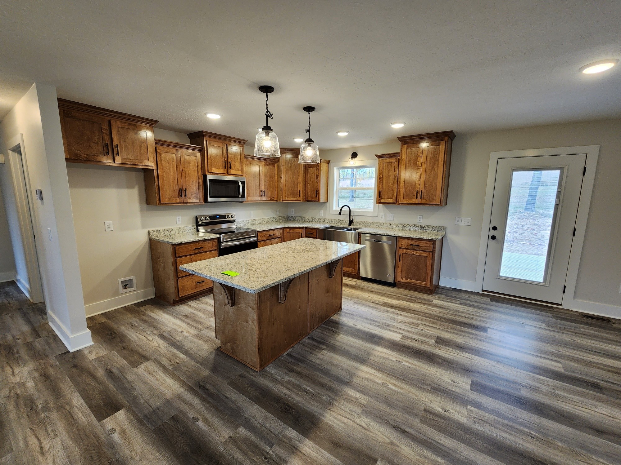 1672 Rock Bridge Road Bethpage, TN 37022 - Photo 10 of 26 a kitchen with stainless steel appliances granite countertop a sink stove and refrigerator