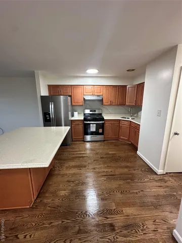 a view of kitchen and wooden floor
